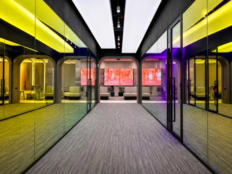 Mapletree: corridor of glass rooms with coloured lighting